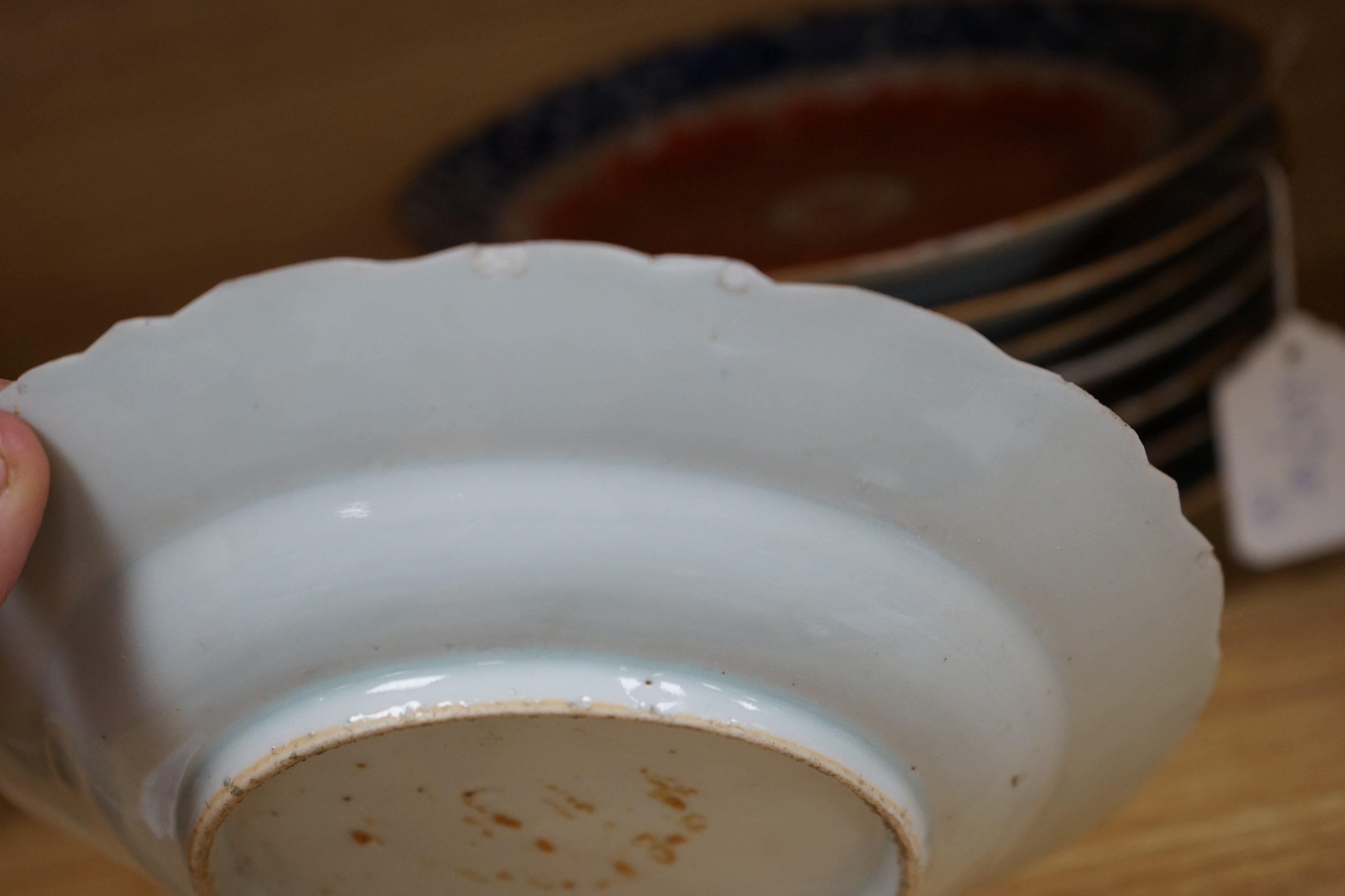 A set of eight Chinese plates with orange 'lotus' centres and blue floral borders, Qing dynasty, Dia 20cm
